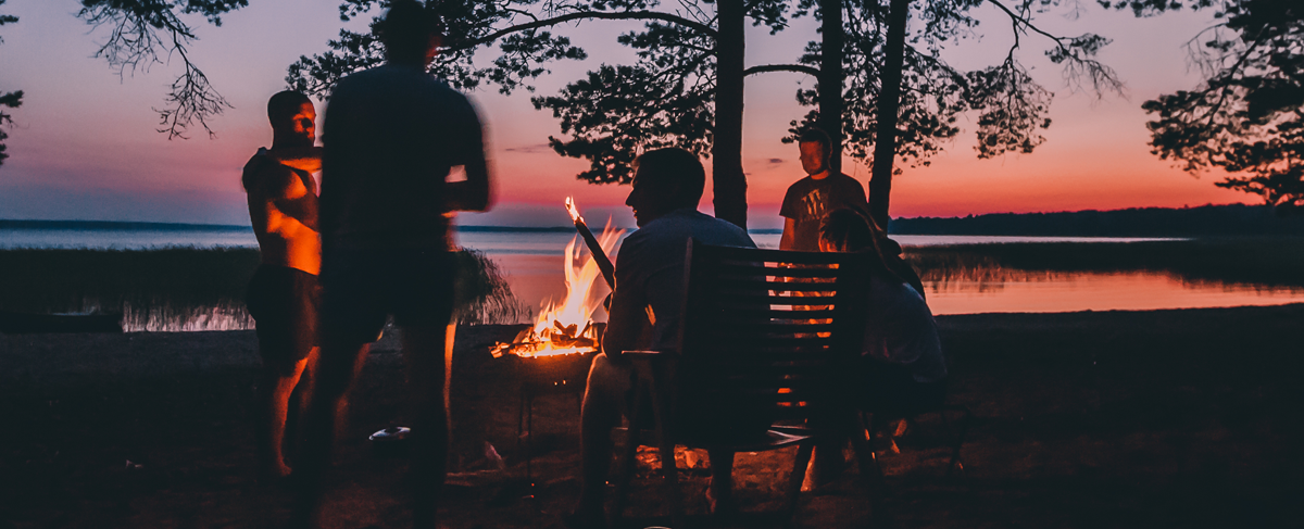 Grilling steaks over campfire