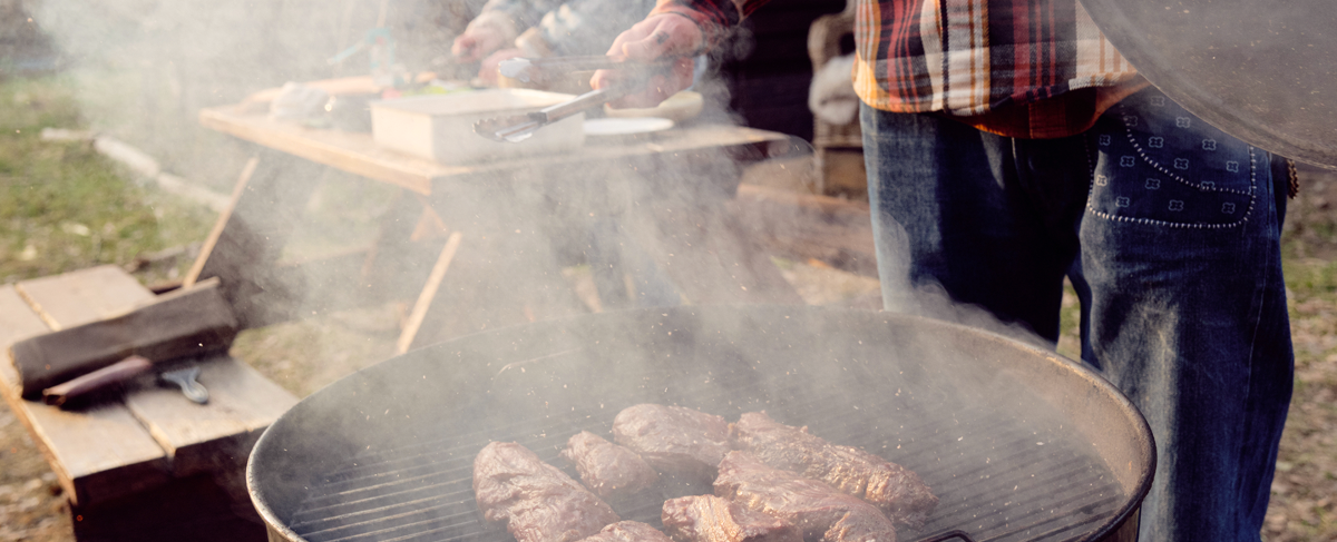 Steaks cooking on a grill